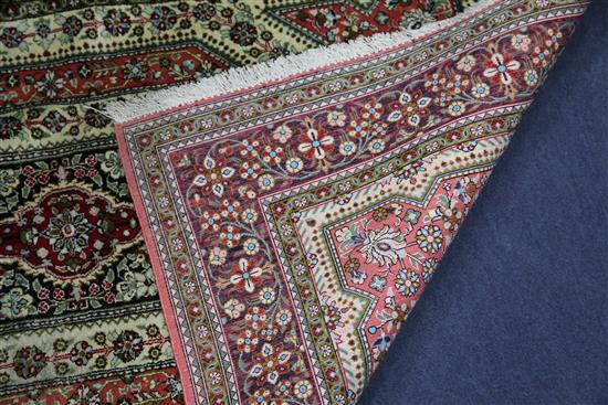 A mathched pair of Qum silk rugs, 5ft 4in by 3ft 4in.